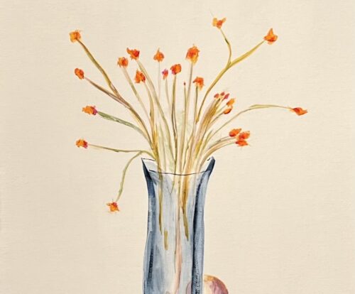 A blue vase with thin tall flowers